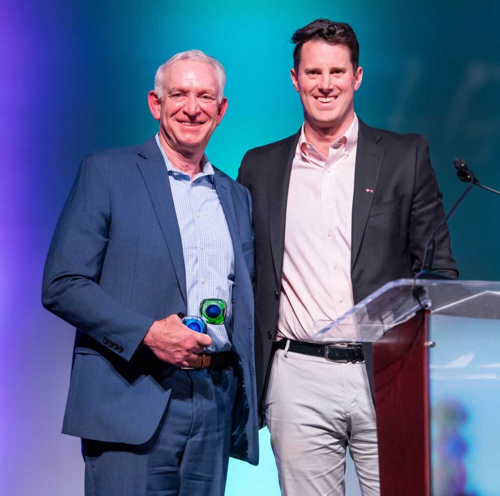 Two men who represent USI accept 2024 Humanitarian of the Year award.