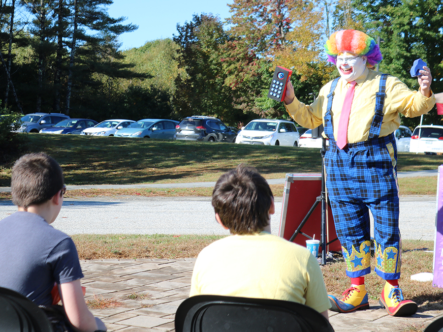 A clown entertaining students