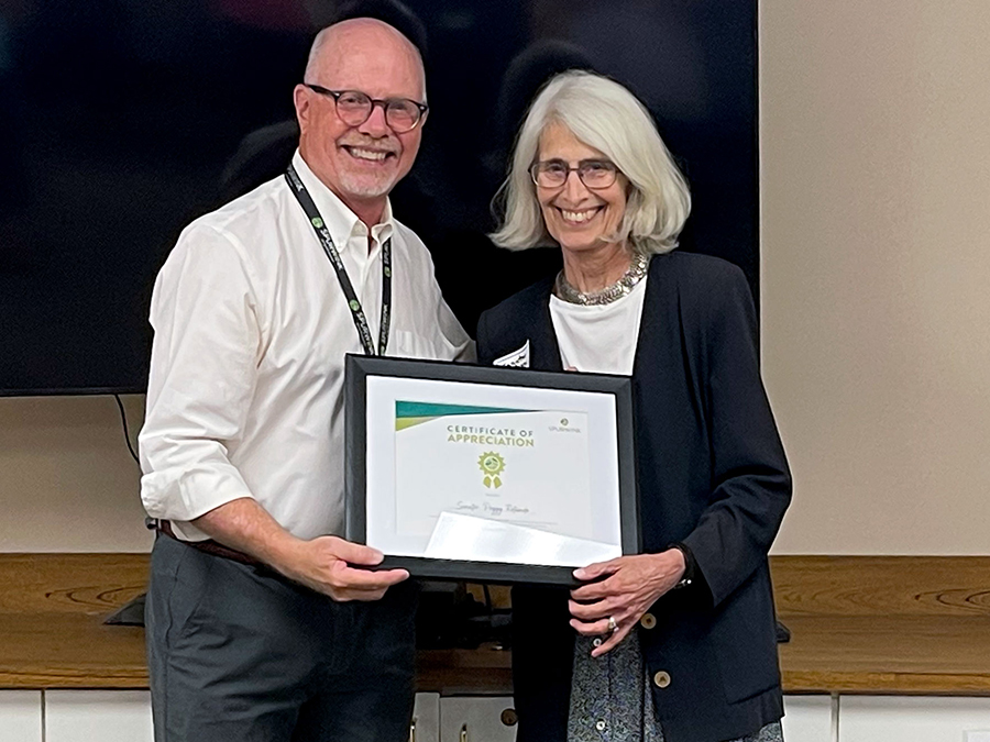 Eric Meyer presenting Senator Peggy Rotundo with an appreciation plaque