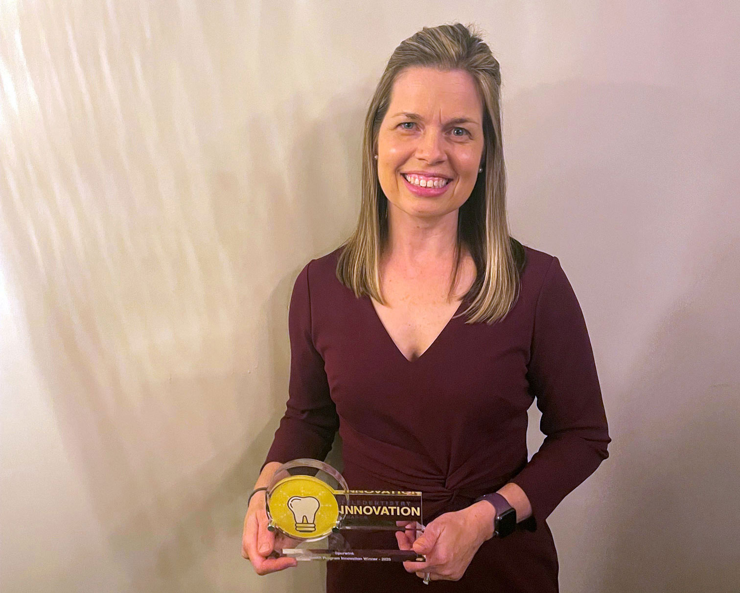 Sarah Labonte holding award