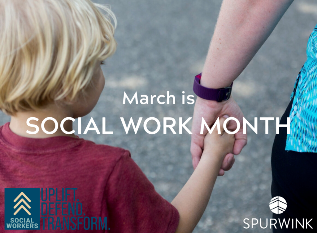 A child holds an adult's hand as they walk.