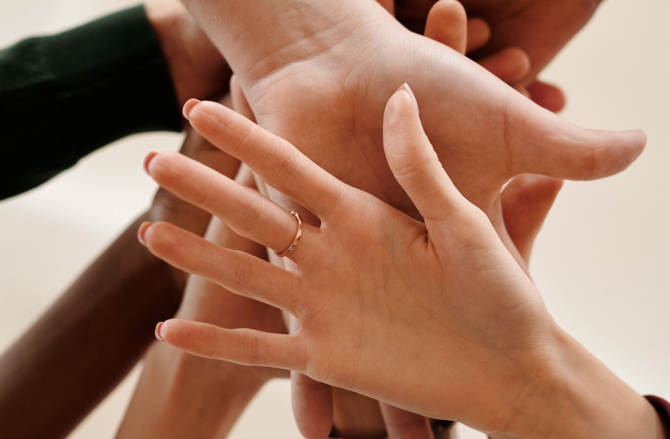 Several hands stacked together